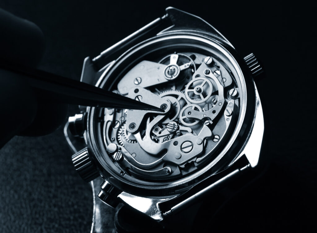 USA Watch Repair: watchmaker working on watch close up detail